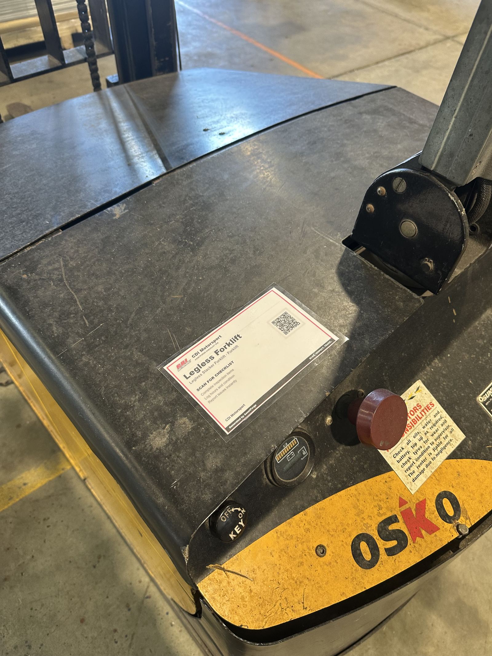 AssetForge QR checklist tag mounted on an electric stacker forklift
